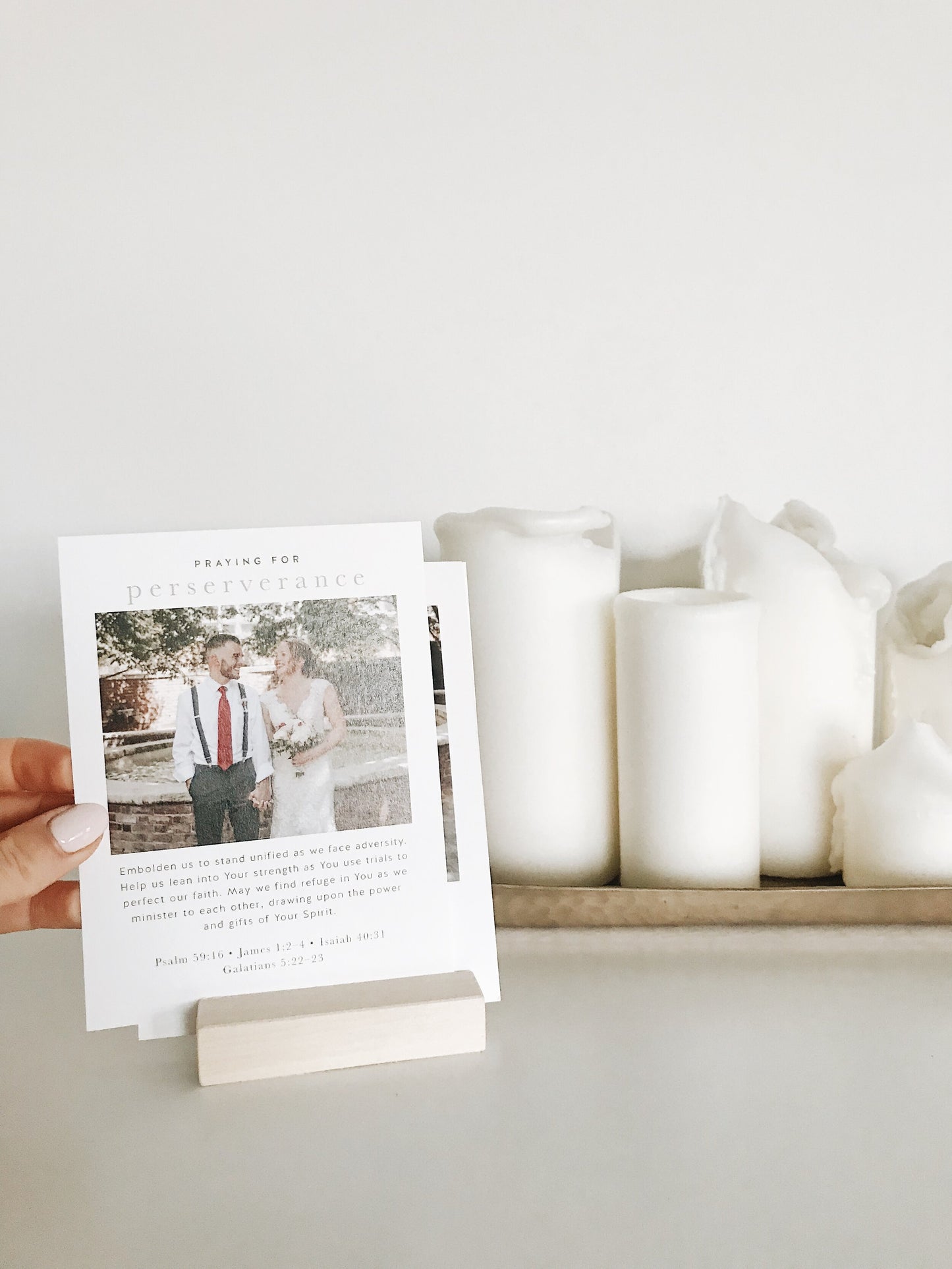 A set of 20 biblically-based prayer cards displayed in a home, personalized with a wedding or engagement photo for married, Christian couples to pray together for their